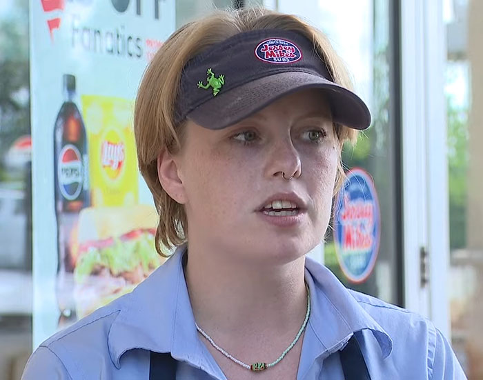 Jersey Mike's employee wearing uniform and visor, sharing story about captive woman's brave cry for help rescue.