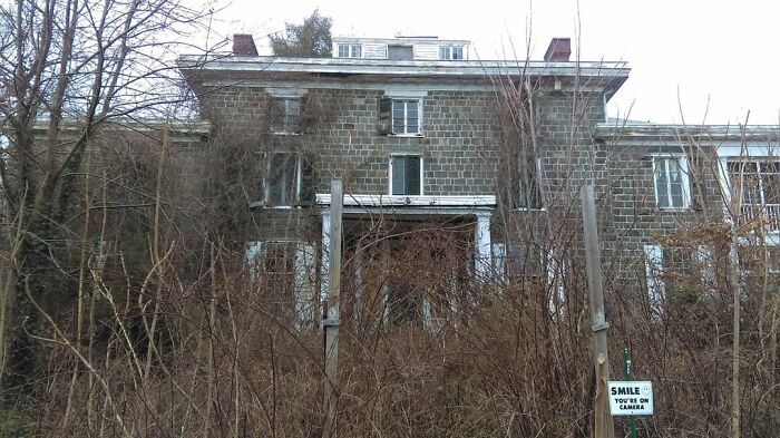 Abandoned explorers encounter creepy scenes like this overgrown, deserted house during their eerie escapades and investigations.