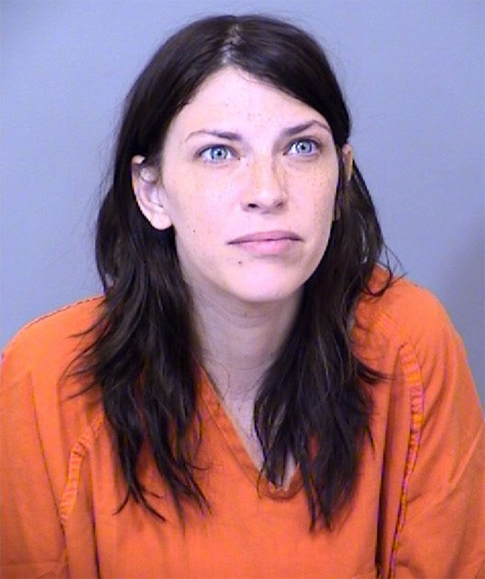 Mugshot of a woman in an orange prison uniform related to raging mom who drove pickup truck through kids park incident.