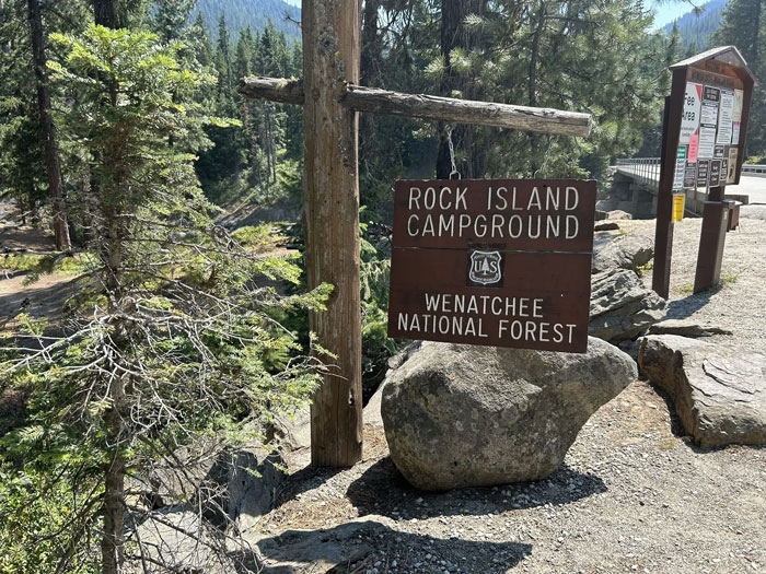 Rock Island Campground sign at Wenatchee National Forest, wooded area, related to tragic cause of passing for 3 sisters.
