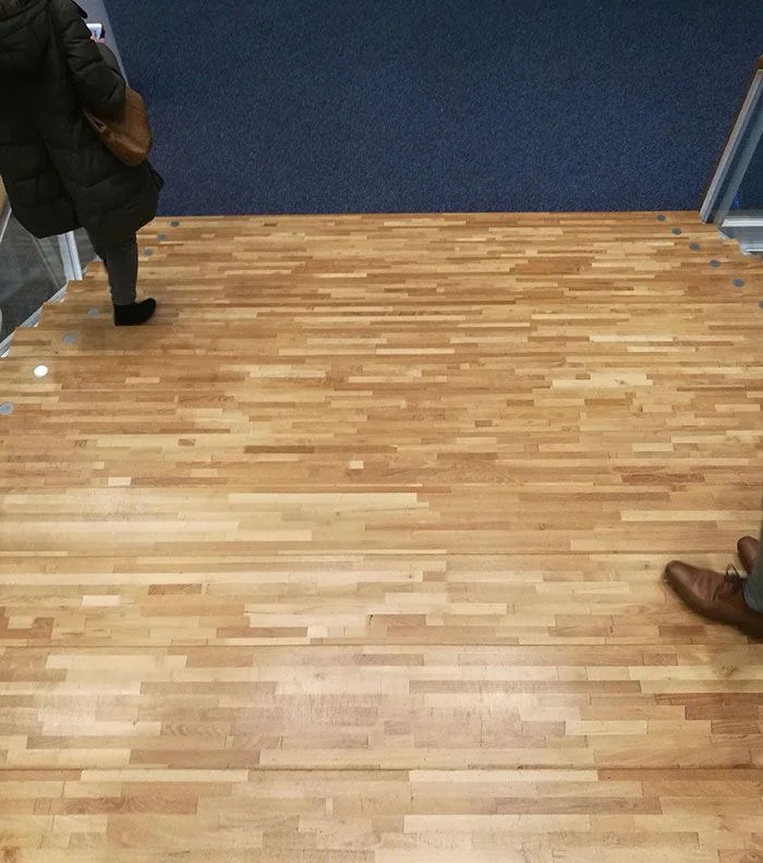 A dangerous optical illusion on death stairs with wooden planks blending into the floor, causing a hidden step hazard.