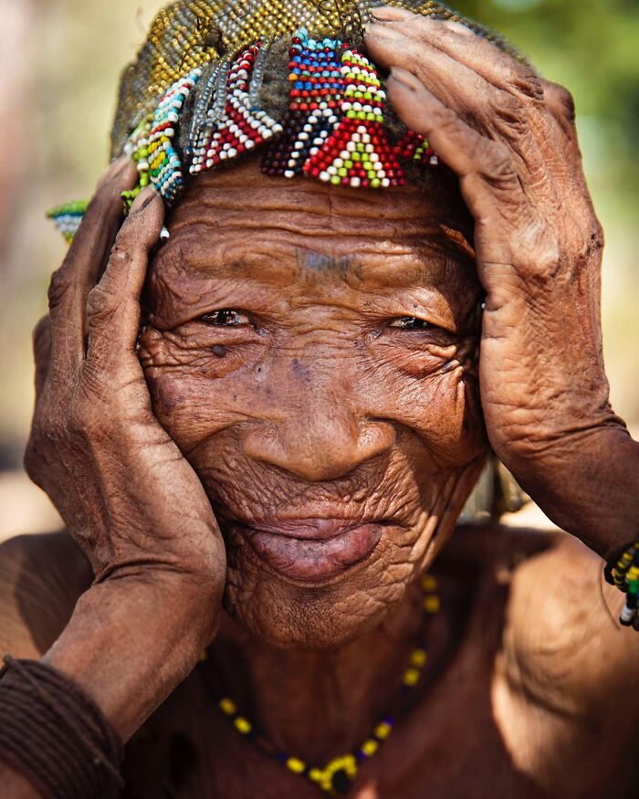 Elderly woman from Africa wearing colorful beaded headwear, smiling and showing beauty has no expiration date.