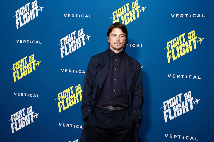 Actor posing at Fight or Flight event, representing stars who said goodbye to the US and Hollywood abroad.