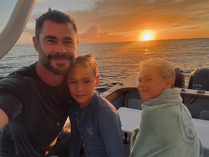 Actor with children on boat at sunset, illustrating stars who said goodbye to the US and found new homes abroad