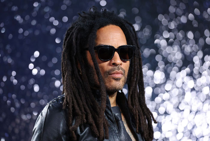 Man with dreadlocks wearing sunglasses and black leather jacket, representing stars who moved abroad from Hollywood.