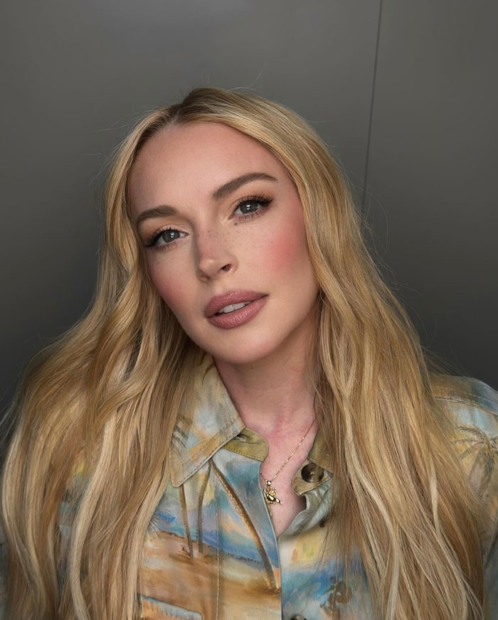 Blonde female star with long hair posing indoors, representing stars who said goodbye to Hollywood and moved abroad.