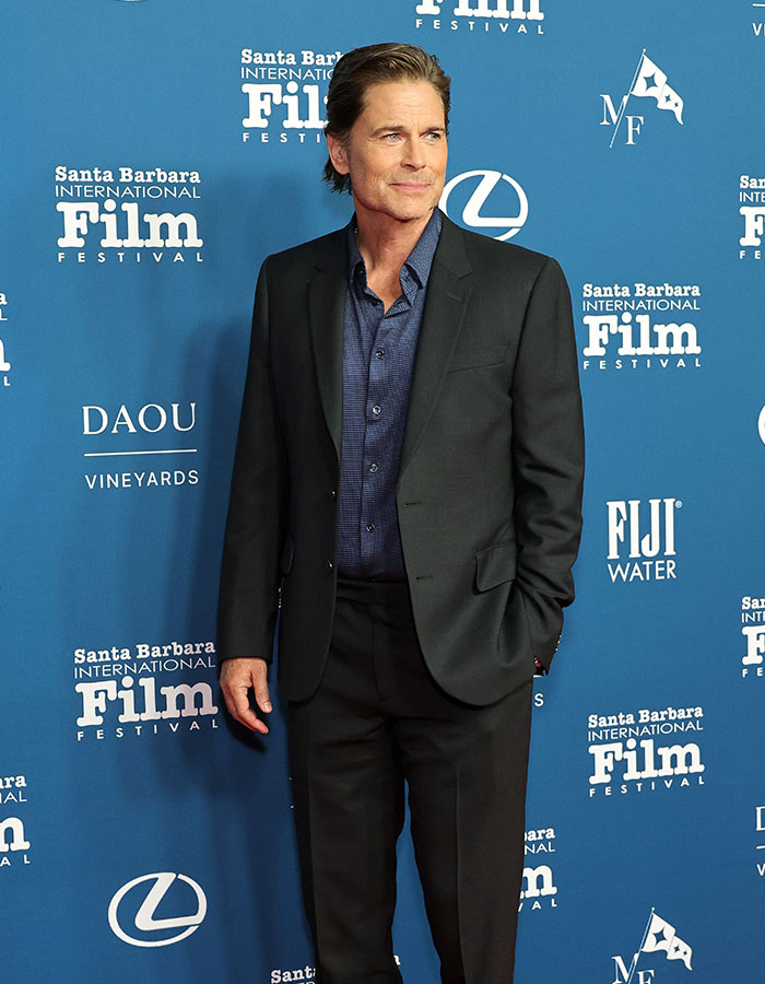 Actor at Santa Barbara Film Festival, wearing a dark suit and blue shirt, showcasing celebrities who look way younger than their age.