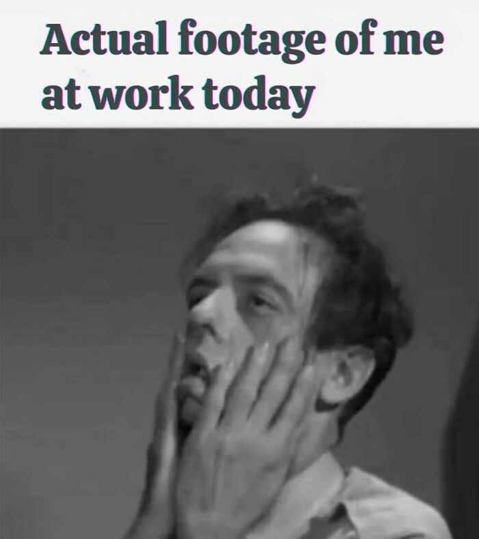 Tired man holding his face in hands with caption about actual footage at work, illustrating funny work memes.