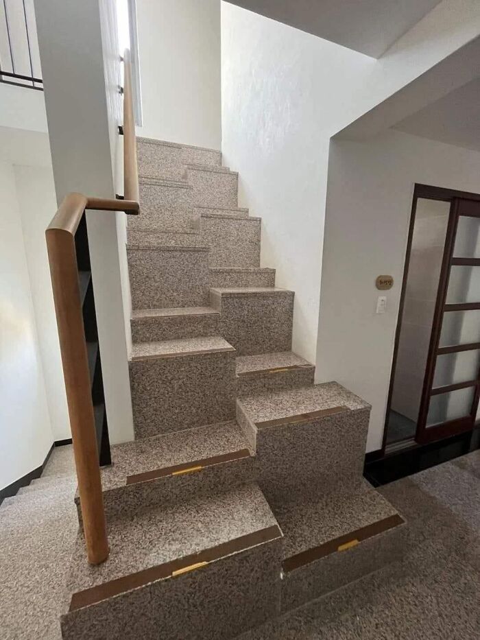 Uneven death stairs with irregular step heights and shapes inside a building, making them unsafe to climb.