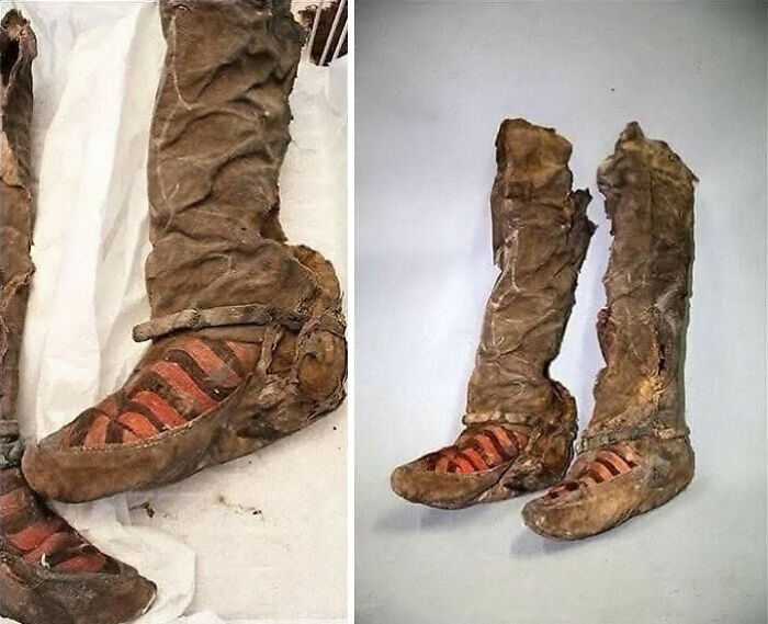 Ancient leather footwear with striped fabric detail preserved in archaeological world historical artifacts collection.