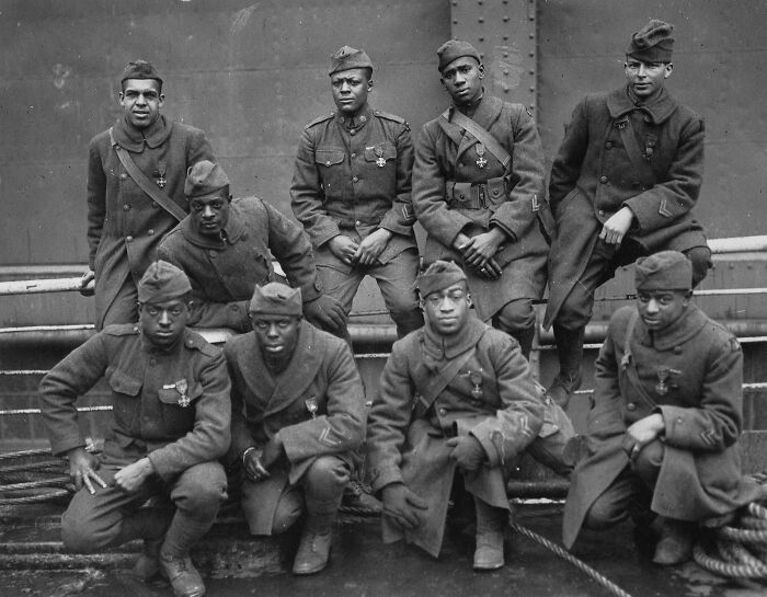 Group of Black soldiers in uniform posing for a photo, representing key moments in the Harlem Renaissance era.