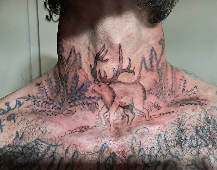 Tattoo of a distorted elk on neck and chest with surrounding ink that appears poorly designed and confusing.