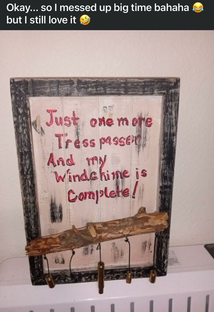 Rustic wooden craft with misspelled words and hanging bullet casings, an example of horrible crafts shamed by netizens.