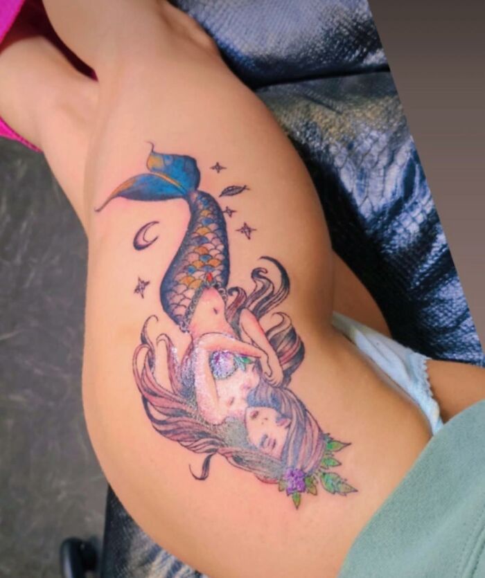Mermaid tattoo on thigh with vibrant colors and details, an example of hilariously bad tattoos in inkshaming collection.