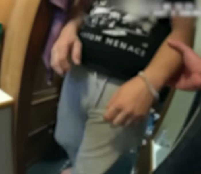 Person in handcuffs being escorted by another inside a room related to human remains found in search efforts Person in handcuffs being escorted by another inside a room related to human remains found in search efforts