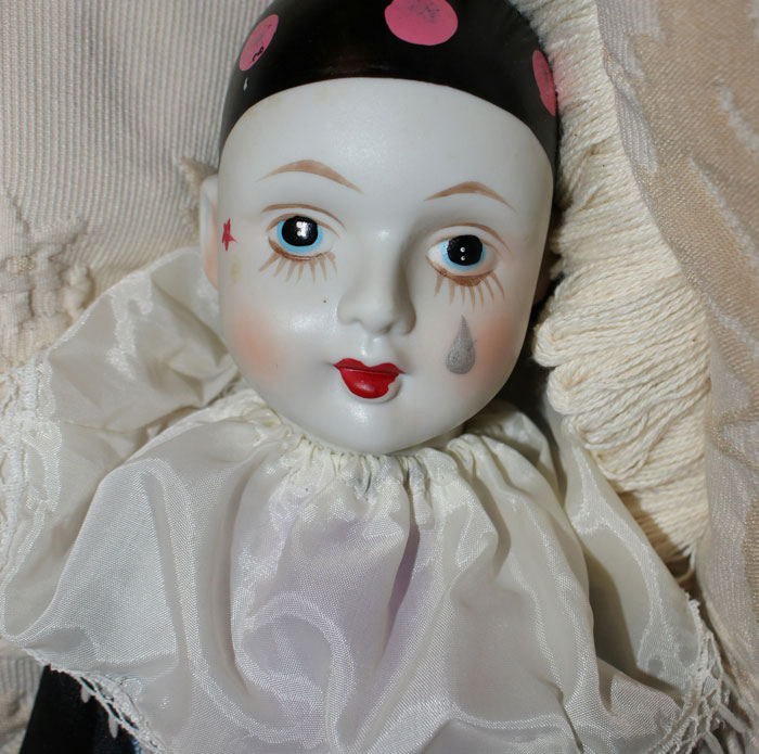 Close-up of a vintage porcelain doll with painted blue eyes and a tear, part of wild things people say they've seen.