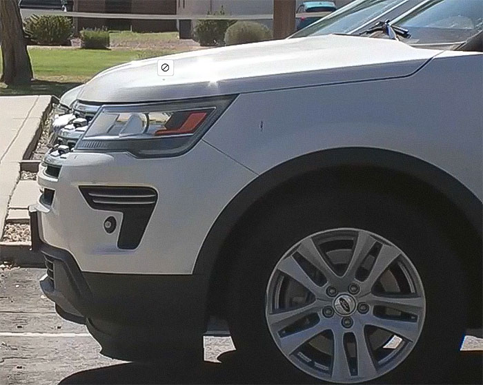 White pickup truck parked near a park, related to a raging mom incident involving a child's leg injury and a ten-year sentence.