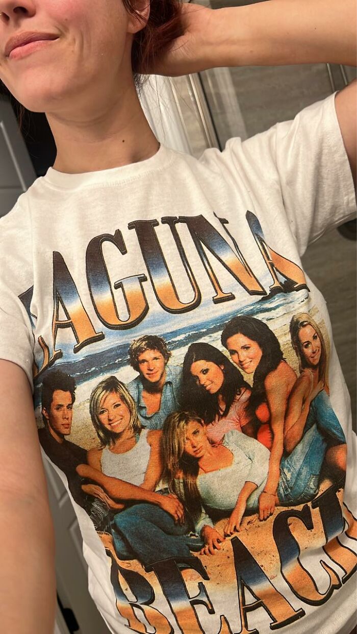 Person wearing a Laguna Beach TV show graphic t-shirt connecting to nostalgic millennial and Gen Z culture.