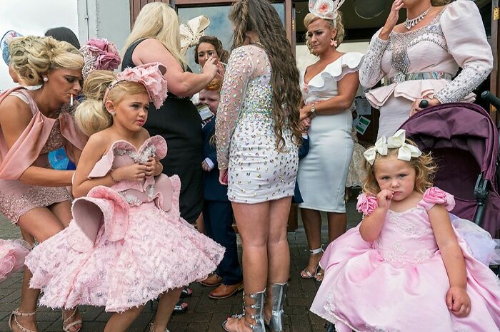 Group of people dressed in elaborate dresses and formal wear, capturing raw and beautiful life on the margins of modern Ireland.