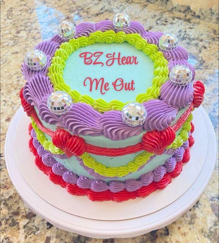 Colorful decorated cake with purple, green, and red icing and disco ball decorations, symbolizing a Gen Z and Millennial connection.