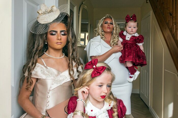 A family dressed in elegant attire inside a home, illustrating life on the margins of modern Ireland.