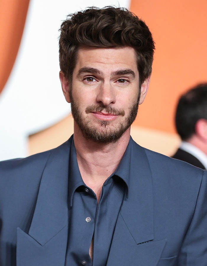 Male celebrity with styled dark hair and beard wearing a blue suit at an event showcasing celebrities who look way younger than they actually are.