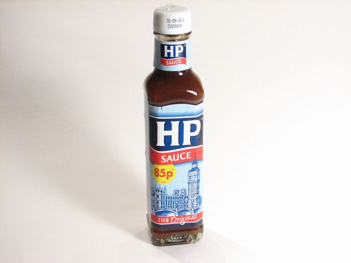 Bottle of HP sauce on a white surface, a popular British condiment reflecting opinions about the UK culture and cuisine.