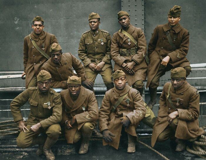 Group of African American soldiers in vintage military uniforms and medals, representing historical events often overlooked in history.