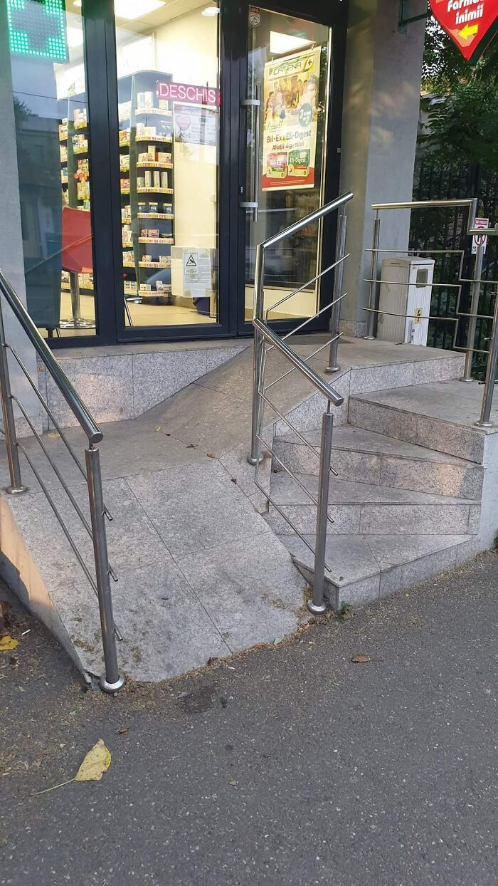 Ramp next to death stairs with sharp incline and unsafe railing outside a store entrance creating a hazard for users.