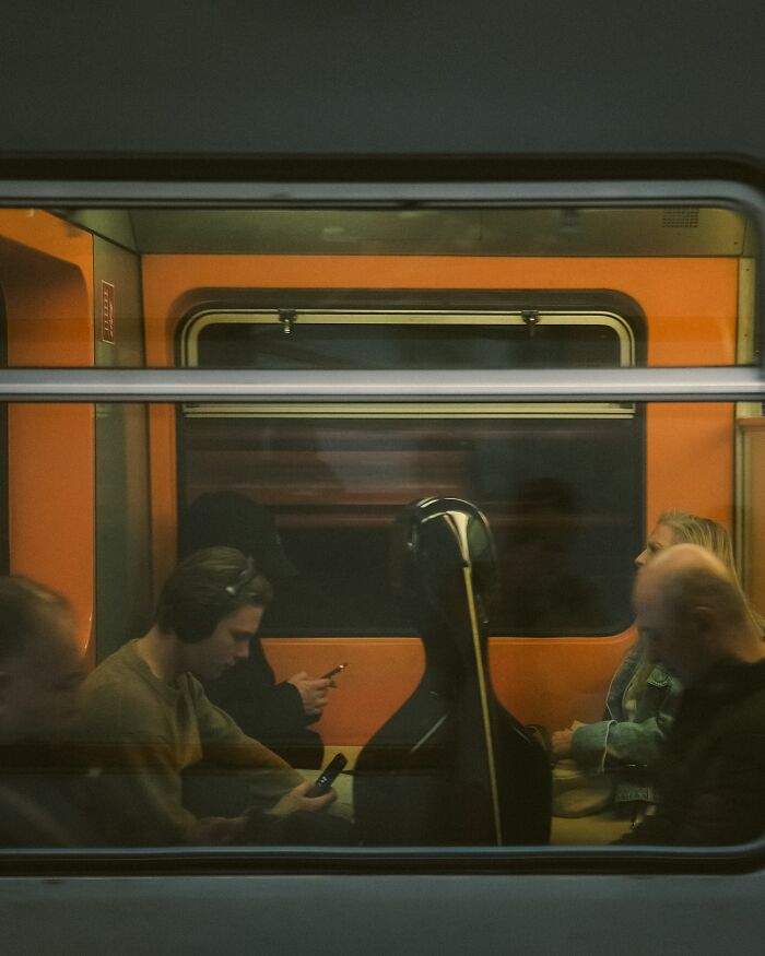 Urban photo of passengers inside a train carriage, captured as a real moment on the street by a Helsinki-based photographer.