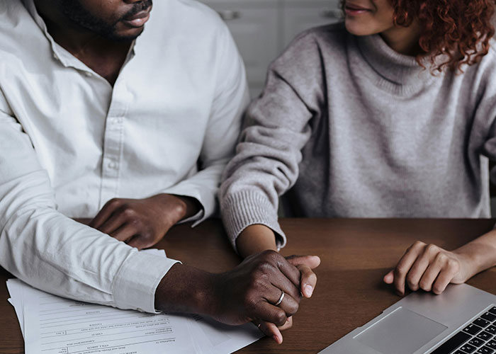 Wife cheats on husband, holding hands in tense moment, sharing unbelievable excuse about being mind-controlled.