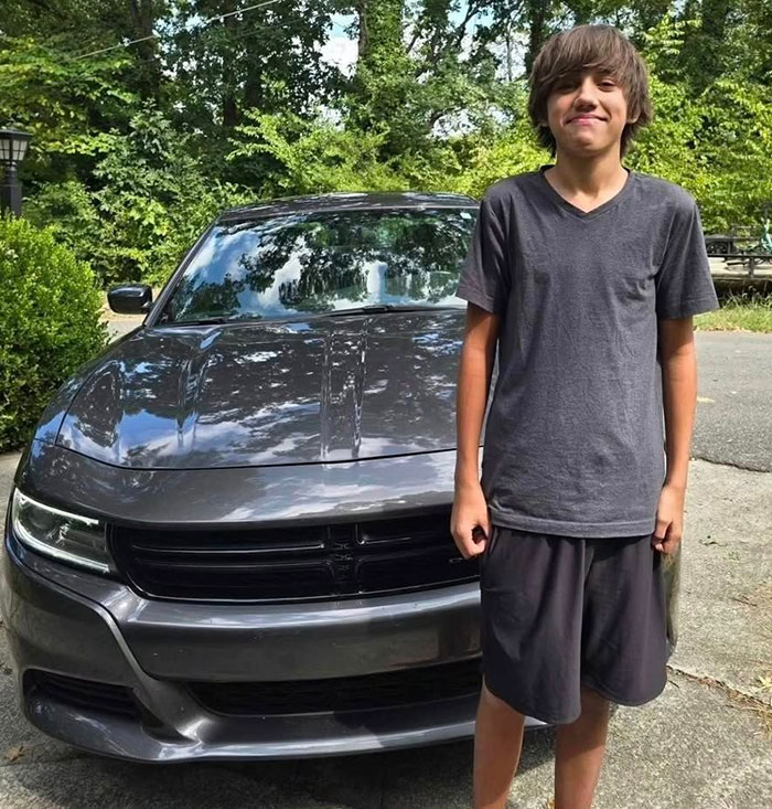 Teen boy standing in front of a gray car outdoors, related to 16 And Pregnant star Whitney Purvis losing her 16-year-old son.