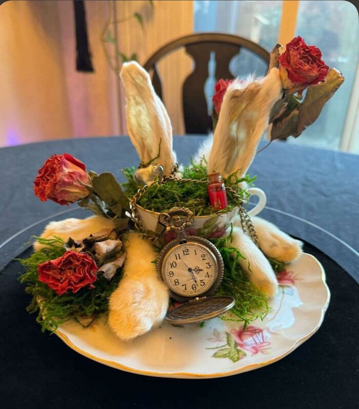 DIY craft project featuring a mismatched arrangement with faux rabbit ears, dried roses, moss, and a vintage pocket watch.