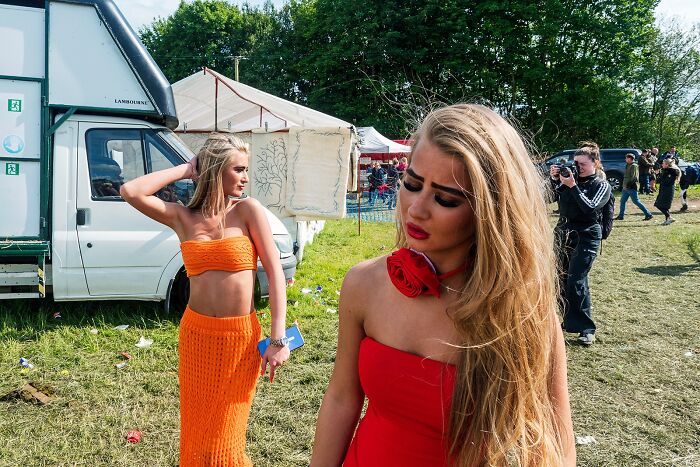 Two young women in bright outfits at an outdoor event, capturing life on the margins of modern Ireland.