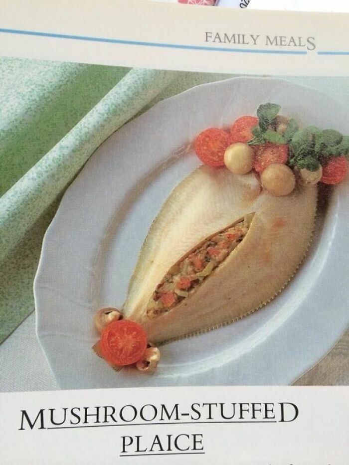 Mushroom-stuffed plaice served on a white plate with tomato slices and garnished with herbs in a family meal setting.