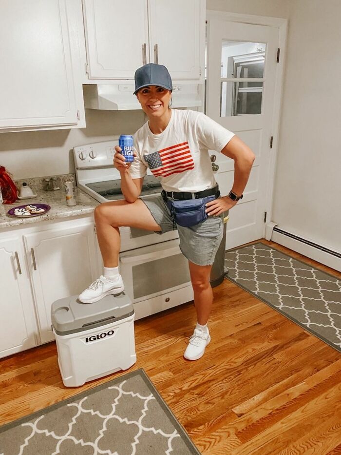 Person in casual outfit holding a can, posing in a kitchen, representing a group for people not relating to Millennials or Gen Z.