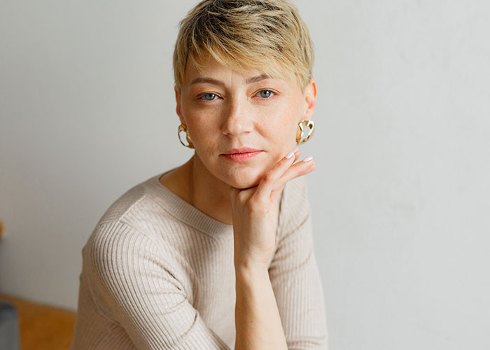 Portrait of a woman with short hair, reflecting on unhinged things men have said about their looks in public.