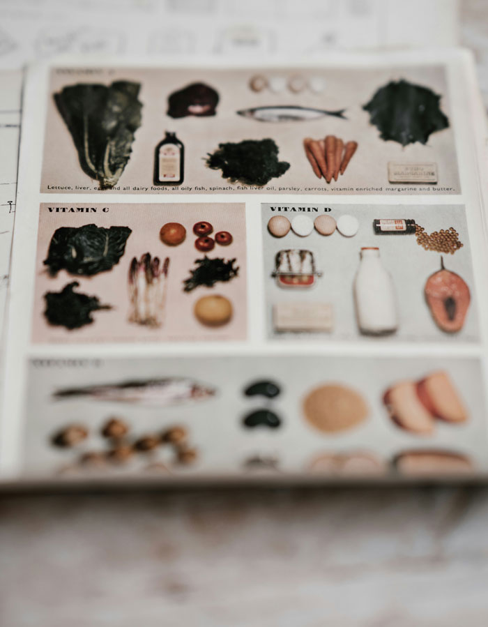 Close-up of a vintage nutrition chart showing foods rich in vitamins, highlighting biggest lies millennials were told.