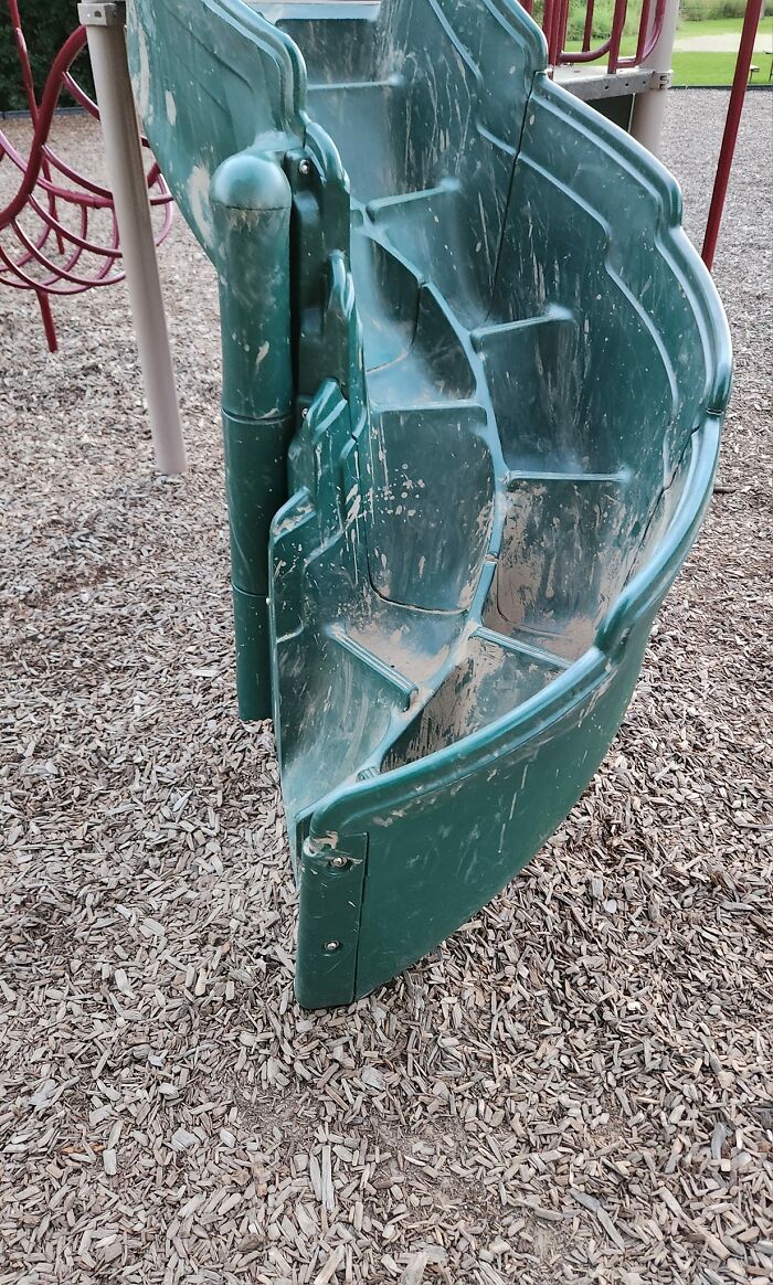 Green plastic playground stairs with unusually narrow and steep steps, making them a death stairs hazard.