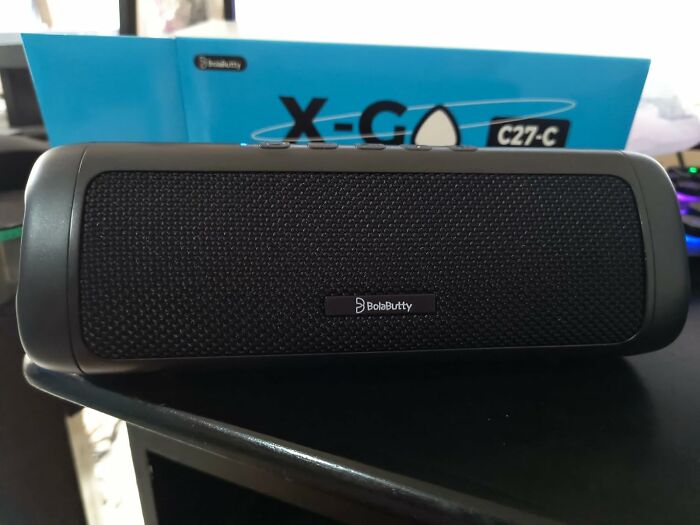 Portable Bluetooth speaker on a table, a must-have for International Picnic Day and al fresco feasts.