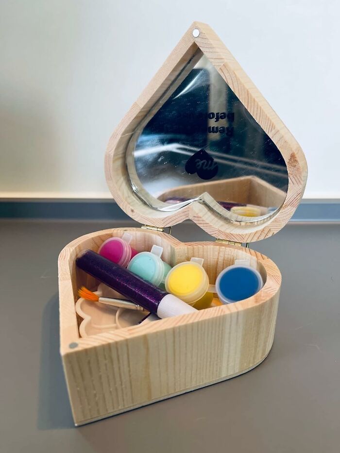 Heart-shaped wooden box with mirror, containing colorful paints and a paintbrush for creative arty finds.