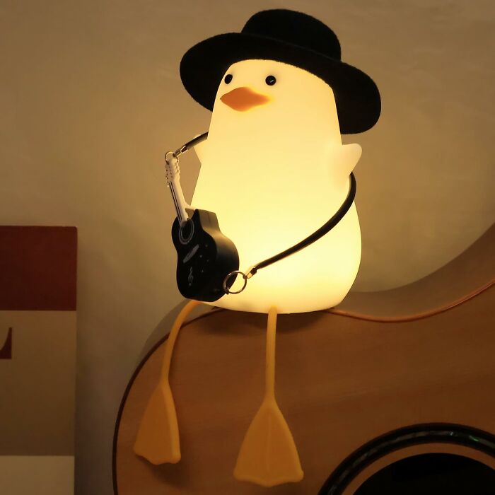 Glowing cute penguin lamp wearing hat and guitar, adding seriously sweet discoveries and aww moments to your life.