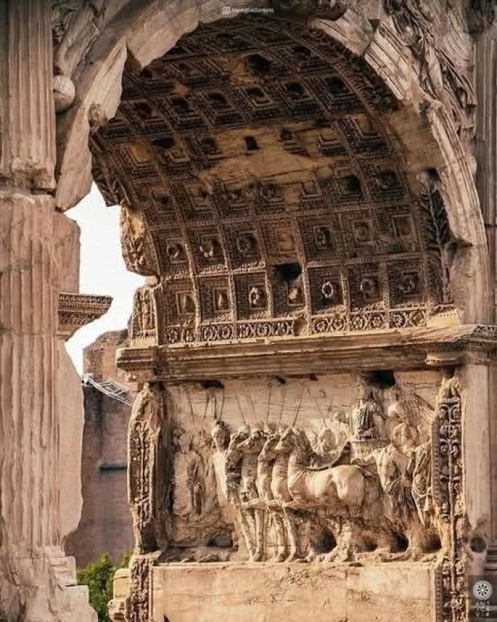 Ancient Roman arch with detailed carvings of horses and warriors, showcasing archaeology world historical architecture.