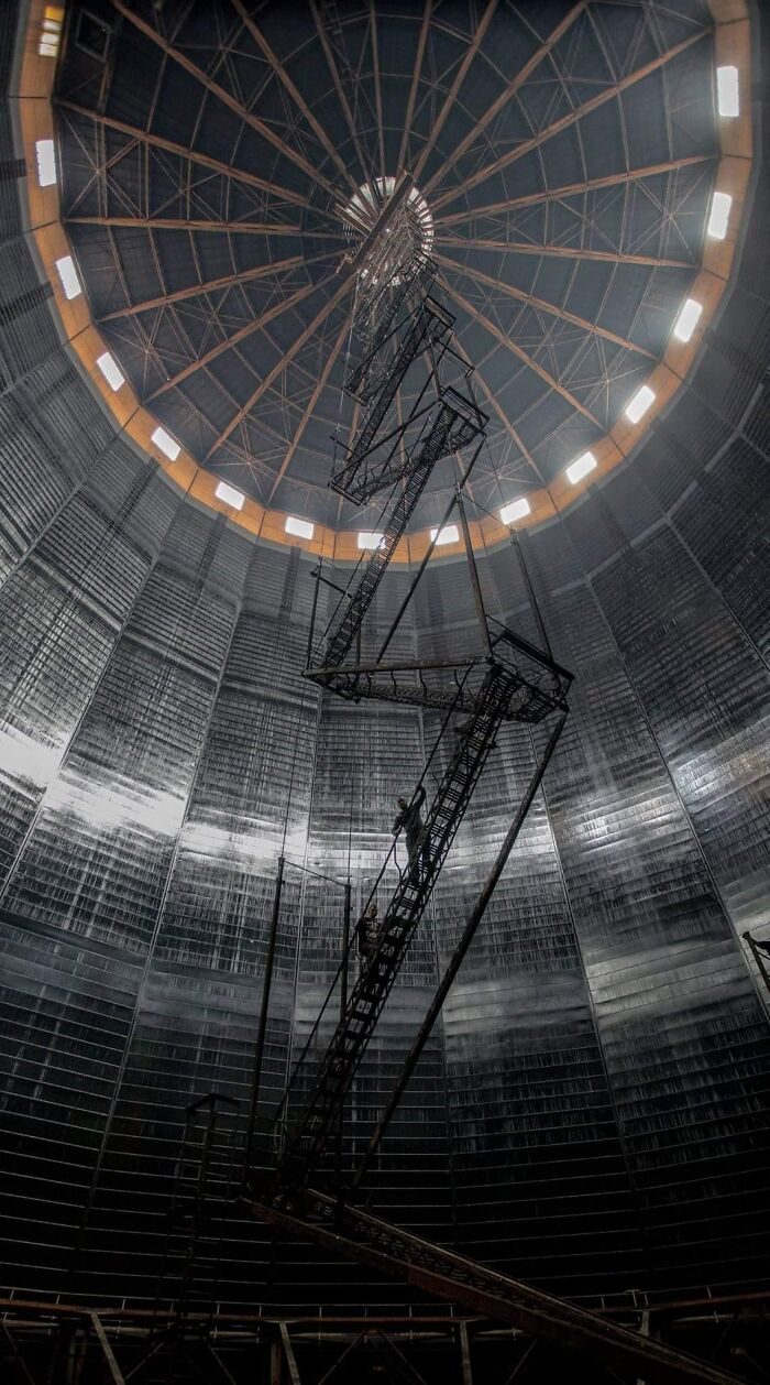 Inside a large cylindrical structure with an extremely tall, narrow, and precarious death stairs extending upward.