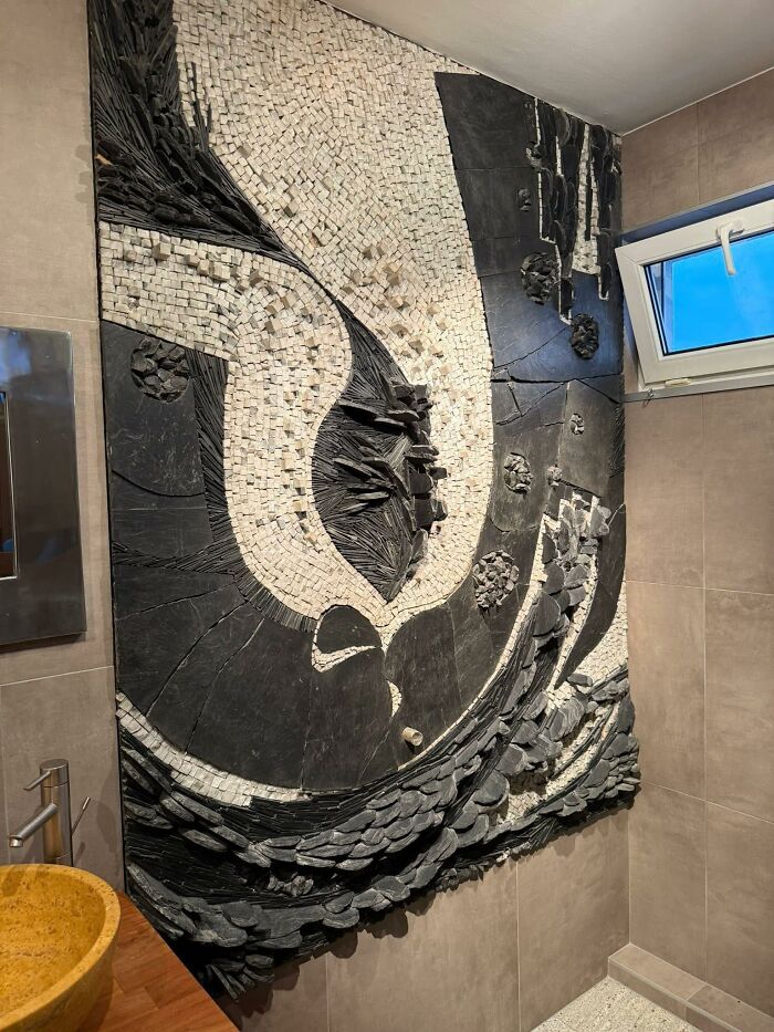 Abstract wall mosaic craft in a bathroom showing a poorly executed and shamed horrible craft by netizens.