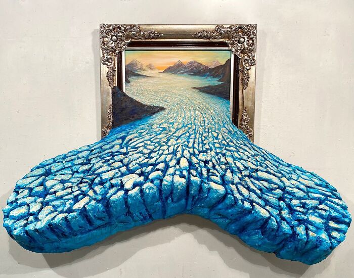 Three-dimensional nature scene combining painting and sculpture with a blue c*****d river flowing out of the frame.