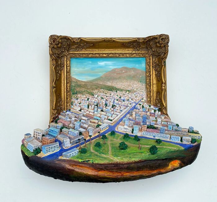 Three-dimensional cityscape sculpture blending painting and sculpture by a Brooklyn artist featuring detailed nature scenes.