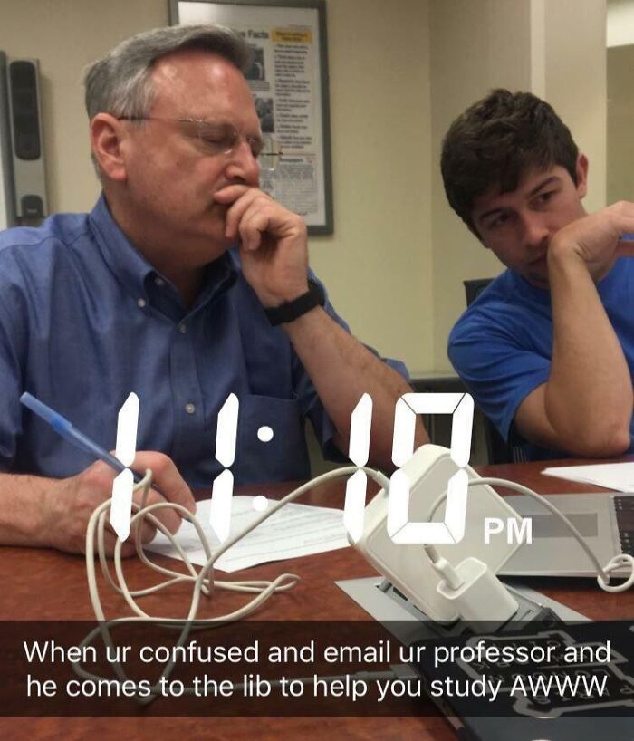 Professor in a blue shirt helping a student study late at night, showing dedication and love for teaching profession.