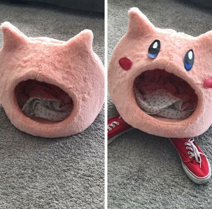 Pink plush cat-shaped pet bed with a blanket inside, showcased as a quirky DIY project idea on carpeted floor.