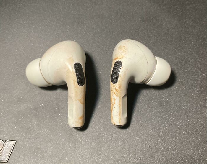 White earbuds with severe dirt and stains, illustrating damage caused by people borrowing and mishandling items.